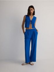 Gładkie spodnie - niebieski. Niebieskie spodnie materiałowe damskie Reserved, l, bez wzorów, z tkaniny. W wyprzedaży za 89.99 zł.