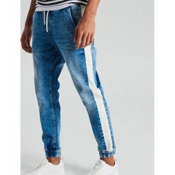 Jeansy slim jogger z materiałowym lampasem - Niebieski. Jeansy męskie marki Cropp. Za 119.99 zł.