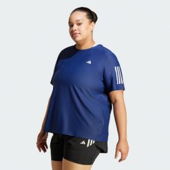 Koszulka Own The Run (Plus Size). Białe t-shirty damskie Adidas, plus size, bez wzorów, z materiału, sportowe, bez kołnierzyka. Za 159.00 zł.