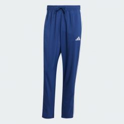 Spodnie Essentials 3-Stripes Stanford Open Hem. Białe buty sportowe męskie Adidas, z materiału, bez zapięcia, na fitness i siłownię. Za 179.00 zł.