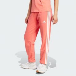 Spodnie Essentials 3-Stripes French Terry Cuffed. Białe obuwie sportowe damskie Adidas, m, bez wzorów, z materiału, na fitness i siłownię. W wyprzedaży za 142.35 zł.