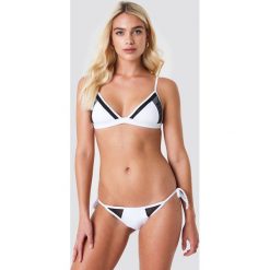 Calvin Klein Dół bikini String Side Tie Bikini-LR - White. Bikini damskie marki Calvin Klein. W wyprzedaży za 54.58 zł.