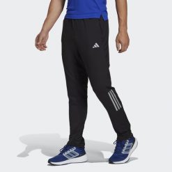 Spodnie Own the Run Astro Knit. Czarne buty sportowe męskie Adidas, bez zapięcia, do biegania. Za 299.00 zł.