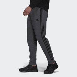 Spodnie męskie adidas Essentials French Terry Tapered Cuff 3-Stripes Pants. Czarne buty sportowe męskie Adidas, bez zapięcia, na fitness i siłownię. Za 182.00 zł.