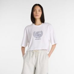 Koszulka damska New Balance WT51935WT – biała. Białe t-shirty damskie New Balance, xl, bez wzorów, z bawełny, bez kołnierzyka. Za 129.99 zł.