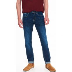 SPODNIE MĘSKIE JEANSOWE O KROJU SLIM Z PRZETARCIAMI. Spodnie materiałowe męskie marki TOP SECRET. W wyprzedaży za 59.99 zł.