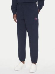 Calvin Klein Jeans Spodnie dresowe Monologo LV047B235G Granatowy Regular Fit. Niebieskie jeansy damskie Calvin Klein Jeans, s, bez wzorów, z bawełny. Za 329.99 zł.