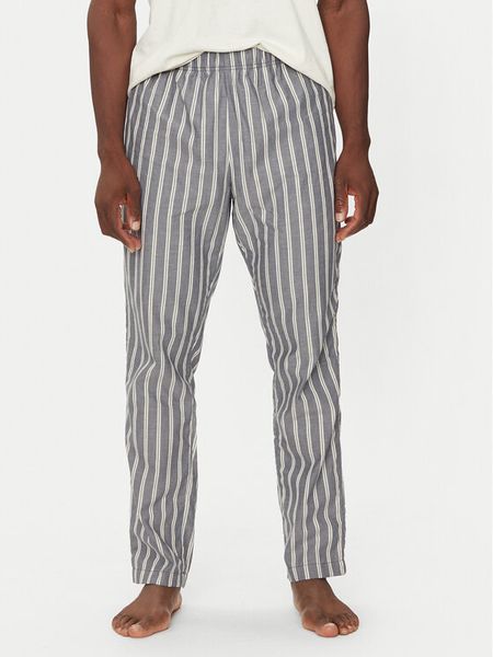 United Colors Of Benetton Spodnie piżamowe 42FK4F00A Granatowy Regular Fit. Niebieskie piżamy męskie United Colors Of Benetton, m, bez wzorów, z bawełny. Za 99.99 zł.