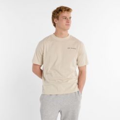 Koszulka męska New Balance MT51507TWF – beżowa. Brązowe koszulki sportowe męskie New Balance, m, bez wzorów, z bawełny, bez kołnierzyka, bez ramiączek. Za 89.99 zł.