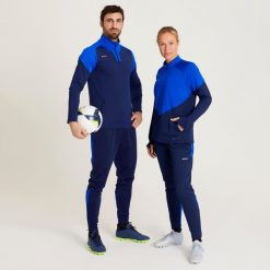Spodnie do piłki nożnej damskie Kipsta Viralto. Niebieskie spodnie materiałowe dla dziewczynek KIPSTA, bez wzorów, z materiału, do biegania. Za 54.99 zł.