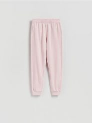 Spodnie dresowe ze ściągaczem - pastelowy róż. Czerwone spodnie dresowe damskie Reserved, l, bez wzorów, z bawełny. Za 79.99 zł.