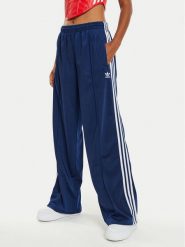 Adidas Spodnie dresowe Firebird IL3817 Granatowy Loose Fit. Niebieskie spodnie dresowe damskie Adidas, s, bez wzorów, z dresówki. Za 239.99 zł.
