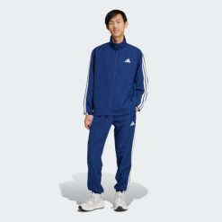Dres Sportswear Basic 3-Stripes Woven. Niebieskie buty sportowe męskie Adidas, z dresówki, bez zapięcia, na fitness i siłownię. Za 299.00 zł.