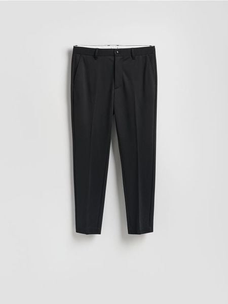 Spodnie chino slim fit - czarny. Czarne spodnie materiałowe męskie Reserved, l, bez wzorów, z dzianiny. Za 139.99 zł.