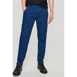 Jeansy tapered fit - Niebieski. Niebieskie jeansy męskie Reserved. Za 149.99 zł.