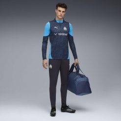 Męskie spodnie treningowe Olympique Marsylia PUMA. Białe spodnie sportowe męskie Puma, m, bez wzorów, z dresówki, do biegania. Za 323.00 zł.