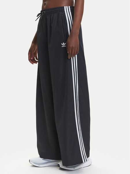 Adidas Spodnie dresowe adicolor Firebird JD3390 Czarny Loose Fit. Czarne spodnie dresowe damskie Adidas, xs, bez wzorów, z dresówki. Za 379.99 zł.