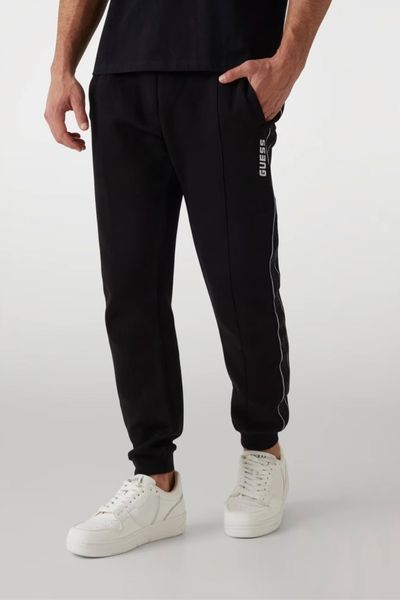 GUESS Czarne męskie spodnie dresowe z lampasami Mickey, Rozmiar XL. Czarne spodnie sportowe męskie Guess, m, z aplikacjami, z bawełny. W wyprzedaży za 222.99 zł.