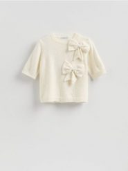 Sweter z kokardami - kremowy. Białe swetry damskie Reserved, l, bez wzorów, z dzianiny, bez kołnierzyka, bez ramiączek, bez kaptura. Za 129.99 zł.