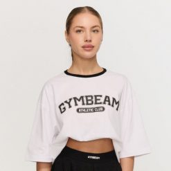Koszulka damska fitness oversize biała Varsity. Białe koszulki sportowe damskie GYMBEAM, l, bez wzorów, z bawełny, klasyczne, bez kołnierzyka. Za 84.90 zł.