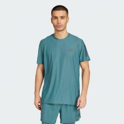 Koszulka Own The Run. Niebieskie koszulki sportowe męskie Adidas, xs, bez wzorów, z materiału, bez kołnierzyka, bez ramiączek, do biegania. Za 149.00 zł.