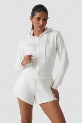 GUESS Biała damska bluza z cyrkoniami Primula. Białe bluzy damskie Guess, s, z aplikacjami, bez kaptura. W wyprzedaży za 227.99 zł.