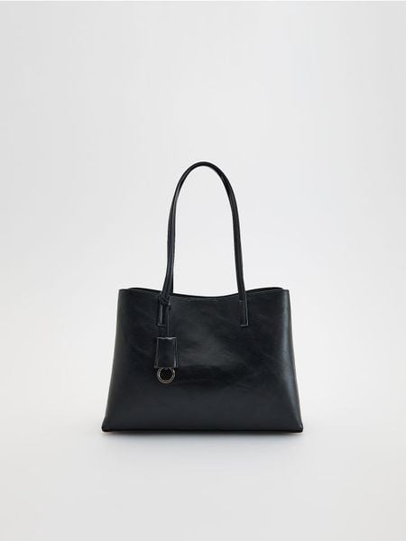 Torebka z zawieszką - czarny. Czarne torebki do ręki damskie Reserved, bez wzorów, ze skóry, bez dodatków. Za 159.99 zł.