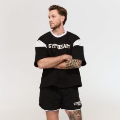 Szorty męskie fitness oversize ze sznurkiem Varsity czarne. Czarne krótkie spodenki sportowe męskie GYMBEAM, l, bez wzorów, z bawełny, na fitness i siłownię. Za 105.90 zł.