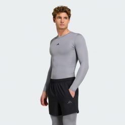 Koszulka TECHFIT Compression Training Long Sleeve. Niebieskie koszulki sportowe męskie Adidas, l, bez wzorów, z dzianiny, bez kołnierzyka, bez ramiączek, techfit (adidas). Za 152.15 zł.