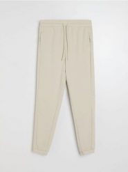 Spodnie jogger - beżowy. Brązowe spodnie materiałowe męskie Sinsay, l, bez wzorów. Za 49.99 zł.