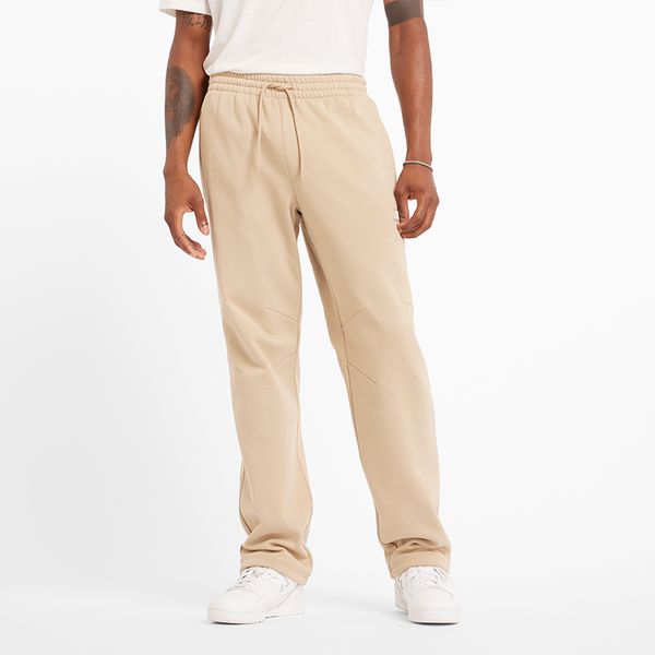 Spodnie męskie New Balance MP44587SNW – beżowe. Brązowe spodnie materiałowe męskie New Balance, m, bez wzorów, z bawełny, klasyczne. Za 199.99 zł.