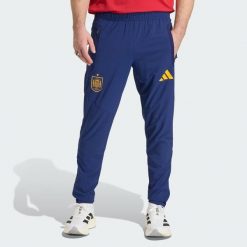 Spodnie Spain Tiro Travel. Niebieskie spodnie sportowe męskie Adidas, bez wzorów, do piłki nożnej. Za 329.00 zł.