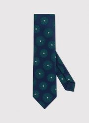 PAKO LORENTE – Granatowy krawat męski w zielone rozetki. Niebieskie krawaty i muchy Pako Lorente, bez wzorów, z poliesteru. Za 69.99 zł.