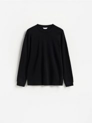 Gładki longsleeve z bawełną - czarny. Czarne bluzki z długim rękawem męskie Reserved, l, bez wzorów, z bawełny, bez kołnierzyka. Za 99.99 zł.