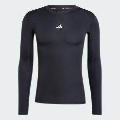Koszulka TECHFIT Compression Training Long Sleeve. Czarne koszulki sportowe męskie Adidas, l, bez wzorów, z dzianiny, bez kołnierzyka, bez ramiączek, na fitness i siłownię, techfit (adidas). Za 179.00 zł.