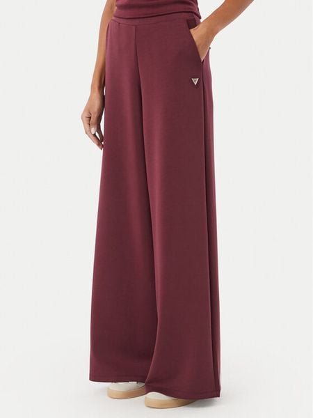 Guess Spodnie dresowe V4YB07 KCAY2 Bordowy Relaxed Fit. Czerwone spodnie dresowe damskie Guess, xxl, z aplikacjami, z dresówki. Za 354.99 zł.