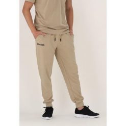 Spodnie do biegania Spalding. Brązowe spodnie sportowe męskie Spalding, bez wzorów, z dresówki, do biegania. Za 338.50 zł.