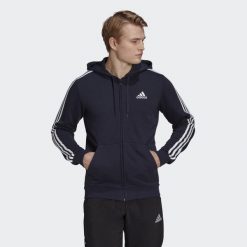 Bluza dresowa męska adidas ESSENTIAL 3 STRIPES. Białe bluzy męskie Adidas, m, bez wzorów, z bawełny, z kapturem. Za 180.99 zł.