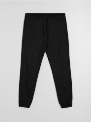 Bawełniane spodnie jogger - czarny. Czarne spodnie materiałowe męskie Sinsay, bez wzorów, z bawełny. Za 49.99 zł.