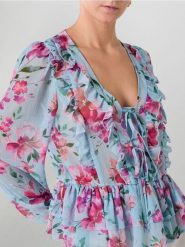Półprzezroczysta bluzka w kwiatowy wzór - wielobarwny. Bluzki damskie Sinsay, l, bez wzorów, bez kołnierzyka, bez ramiączek. Za 39.99 zł.