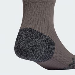 Getry Real Madrid 24/25 Third. Brązowe legginsy sportowe męskie Adidas, bez wzorów, z materiału, do piłki nożnej. Za 118.00 zł.