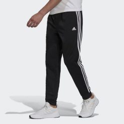 Spodnie męskie adidas Primegreen Essentials Warm-Up Tapered 3-Stripes Track. Białe spodnie sportowe męskie Adidas, m, bez wzorów, z poliesteru, na fitness i siłownię. W wyprzedaży za 156.85 zł.