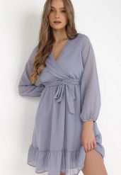 Niebieska Sukienka Pronestra. Niebieskie sukienki damskie Born2be, l, bez wzorów, z materiału, eleganckie, bez kołnierzyka, bez ramiączek, mini, kopertowe. Za 99.99 zł.