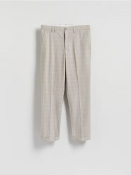 Spodnie slim fit w kratę - beżowy. Brązowe spodnie materiałowe męskie Reserved, bez wzorów, z tkaniny. Za 169.99 zł.