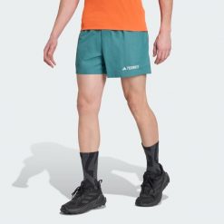 Szorty Terrex Multi. Niebieskie krótkie spodenki sportowe męskie Adidas, uniwersalny, bez wzorów, trekkingowe. W wyprzedaży za 142.35 zł.