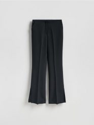 Spodnie z rozcięciami long leg - czarny. Czarne spodnie materiałowe damskie Reserved, l, bez wzorów, z tkaniny. Za 129.99 zł.