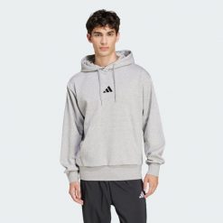 Bluza polarowa Essentials Feelcozy. Czarne bluzy męskie Adidas, xs, bez wzorów, z bawełny, z kapturem. Za 219.00 zł.