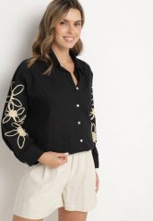 Czarna Bawełniana Koszula Oversize z Kwiatowymi Aplikacjami Fadella. Czarne bluzki damskie Born2be, s, z aplikacjami, z bawełny, eleganckie, bez kołnierzyka, bez ramiączek. Za 74.99 zł.