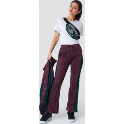 NA-KD Spodnie sportowe z rozcięciem - Purple. Fioletowe spodnie sportowe damskie NA-KD, w paski, z poliesteru. Za 161.95 zł.