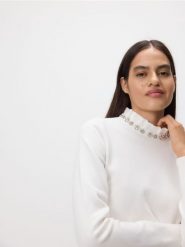 Sweter z ozdobną aplikacją - kremowy. Białe swetry damskie Reserved, l, z aplikacjami, z dzianiny, bez kołnierzyka, bez ramiączek, bez kaptura. Za 129.99 zł.